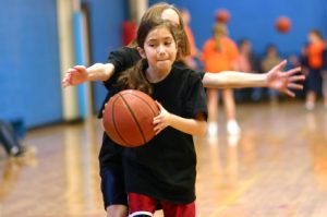 Young_girl_basketball_player_being_guarded